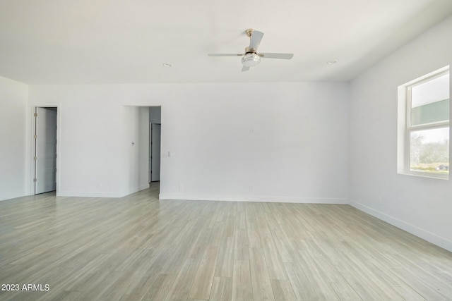 empty room featuring ceiling fan and light wood-type flooring