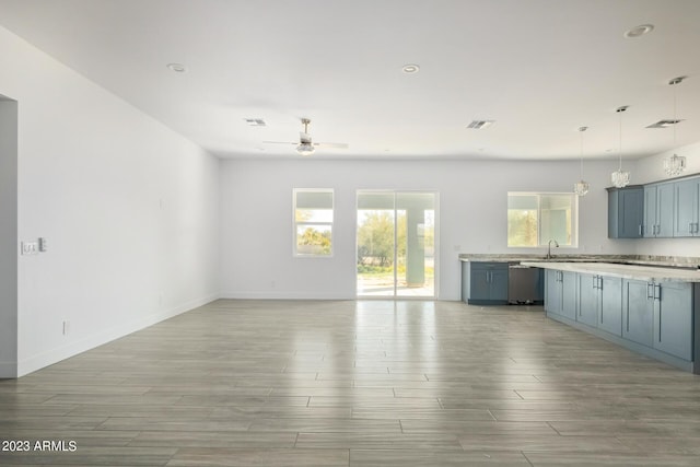 kitchen with dishwasher, sink, hanging light fixtures, ceiling fan, and blue cabinetry