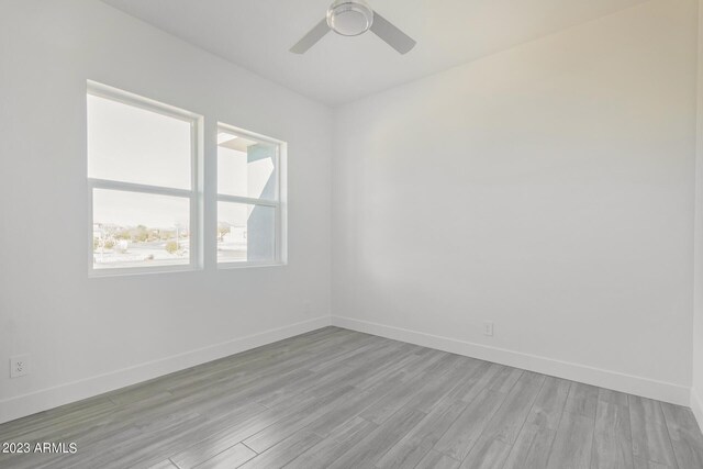 spare room featuring ceiling fan and light hardwood / wood-style flooring