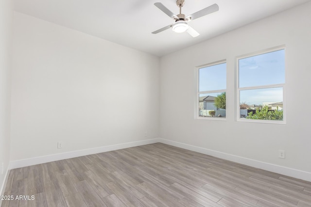 spare room featuring ceiling fan and light wood-type flooring