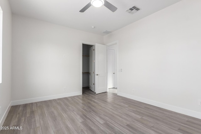 unfurnished room with light hardwood / wood-style flooring and ceiling fan