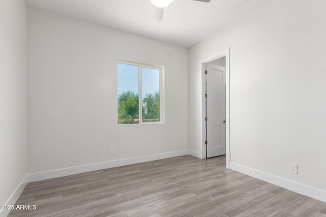 empty room featuring light hardwood / wood-style flooring and ceiling fan