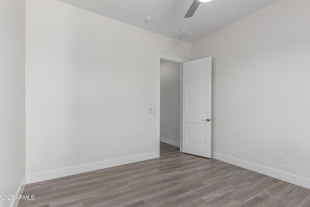 empty room featuring ceiling fan and light wood-type flooring