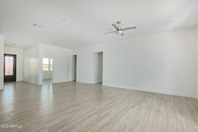 spare room with ceiling fan and light wood-type flooring