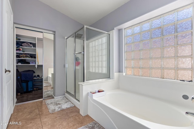 bathroom with tile patterned floors and plus walk in shower