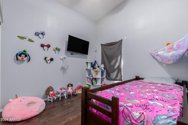 bedroom with vaulted ceiling and dark hardwood / wood-style floors