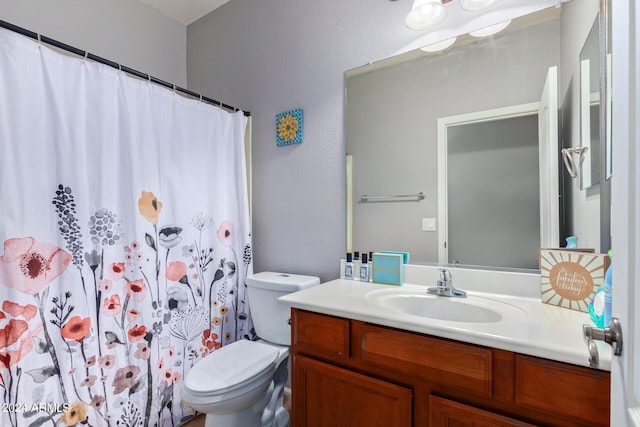 bathroom with vanity, toilet, and a shower with shower curtain