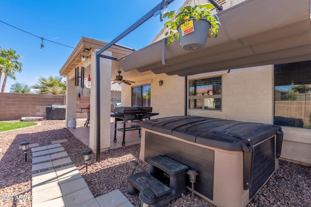 view of patio / terrace with a hot tub and ceiling fan