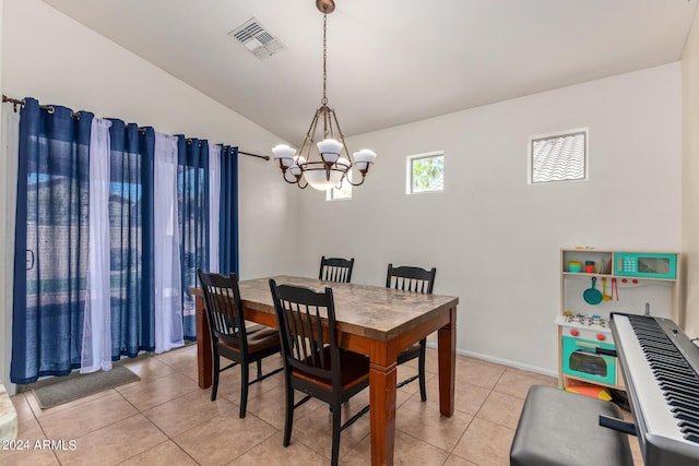 dining room featuring lofted ceiling, light tile patterned floors, and an inviting chandelier