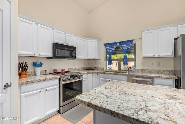 kitchen with sink, light tile patterned floors, white cabinets, and appliances with stainless steel finishes