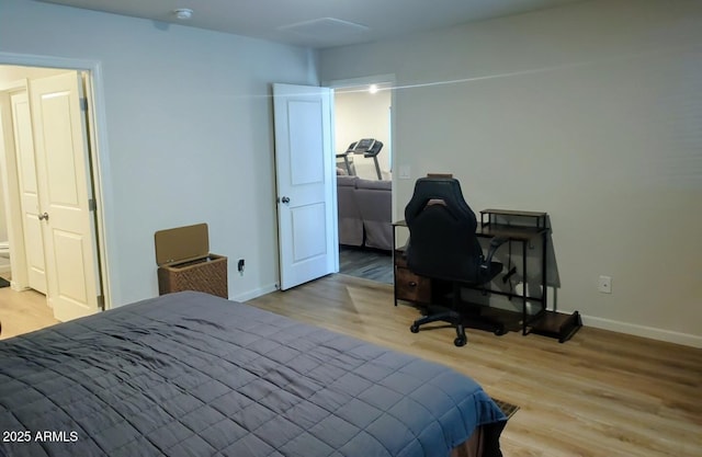 bedroom with wood finished floors and baseboards