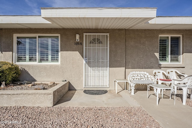 entrance to property featuring a patio