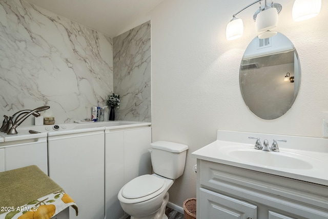 bathroom featuring vanity and toilet