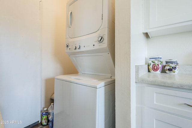 clothes washing area featuring stacked washer and clothes dryer