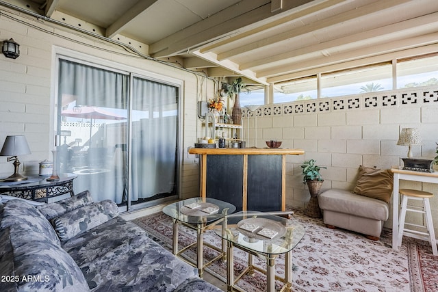 living room featuring beam ceiling and a wealth of natural light