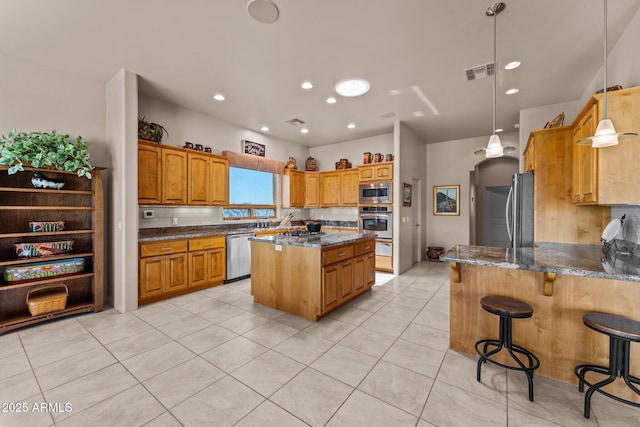 20910 W Cattle Iron Dr, Wickenburg, AZ 85390 - kitchen with visible vents, tasteful backsplash, appliances with stainless steel finishes, and light tile patterned floors