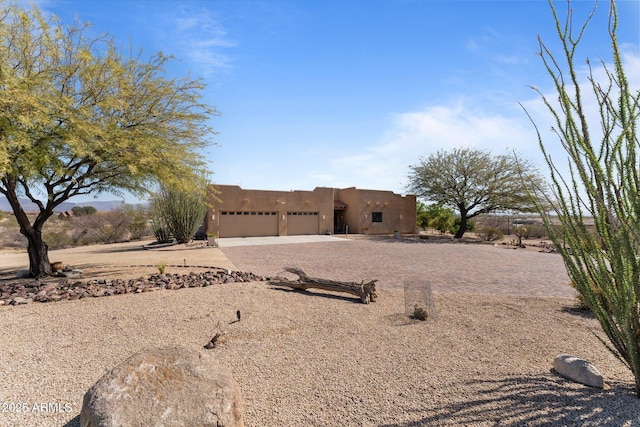 20910 W Cattle Iron Dr, Wickenburg, AZ 85390 - southwest-style home featuring stucco siding, a garage, and concrete driveway