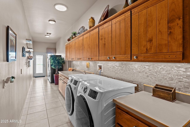20910 W Cattle Iron Dr, Wickenburg, AZ 85390 - laundry area featuring independent washer and dryer, a sink, cabinet space, and light tile patterned floors
