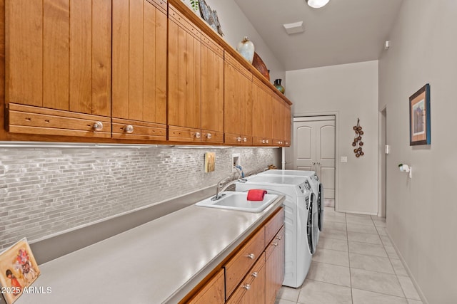 20910 W Cattle Iron Dr, Wickenburg, AZ 85390 - laundry room featuring washer and clothes dryer, a sink, light tile patterned floors, baseboards, and cabinet space