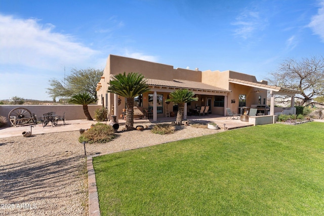 20910 W Cattle Iron Dr, Wickenburg, AZ 85390 - rear view of house featuring fence, stucco siding, a yard, and a patio