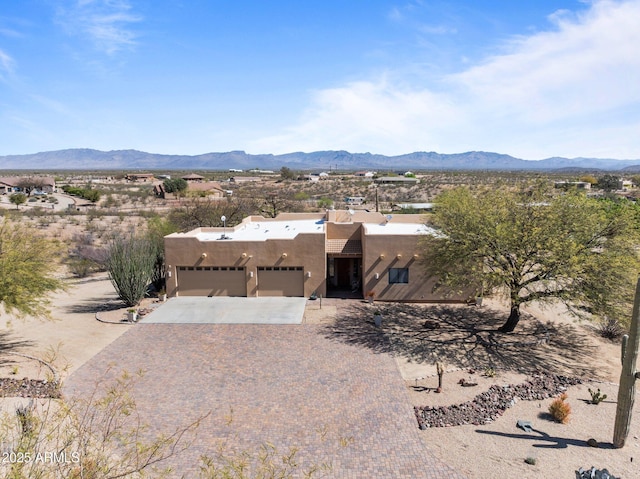 20910 W Cattle Iron Dr, Wickenburg, AZ 85390 - exterior space featuring driveway, an attached garage, and a mountain view