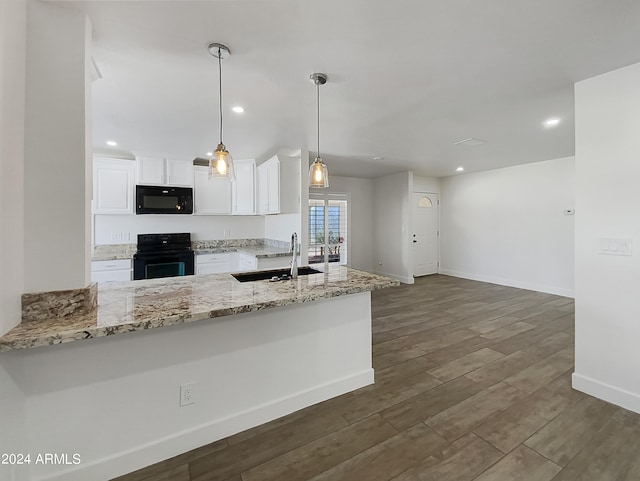 kitchen featuring white cabinetry, black appliances, kitchen peninsula, sink, and light stone countertops