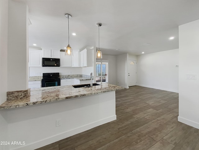 kitchen featuring dark wood finished floors, light stone counters, black appliances, white cabinetry, and a sink