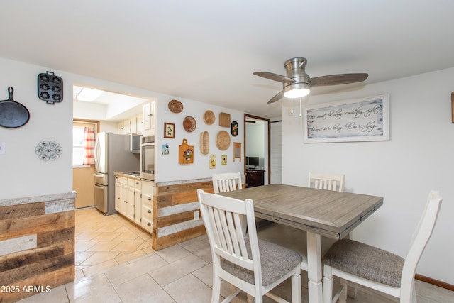 dining area with ceiling fan and light tile patterned floors