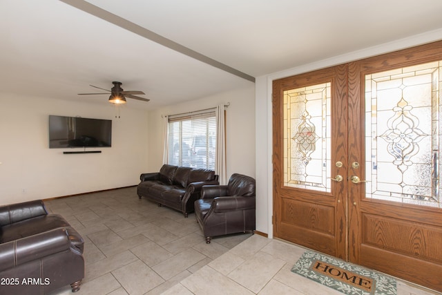 foyer with ceiling fan and french doors