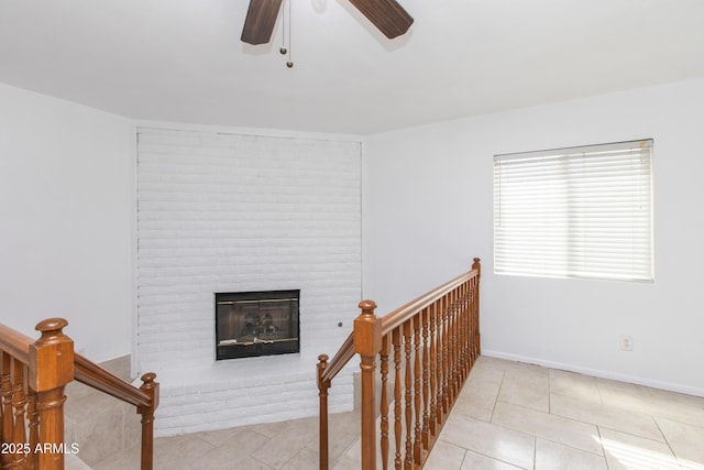 interior space with a fireplace and ceiling fan