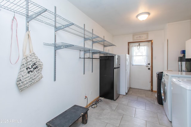 laundry area with light tile patterned floors and independent washer and dryer