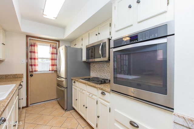 kitchen featuring stainless steel appliances, tasteful backsplash, sink, and white cabinets