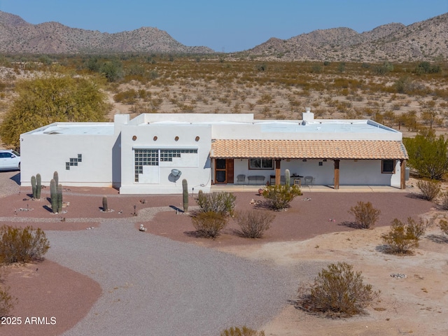 exterior space with a mountain view and a patio