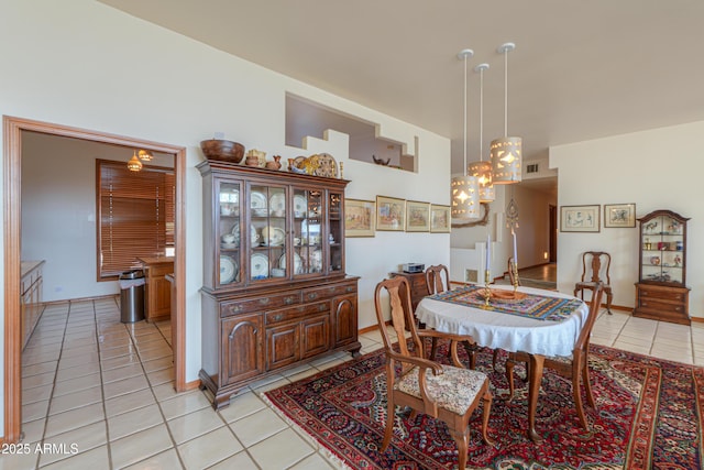 tiled dining room featuring an inviting chandelier