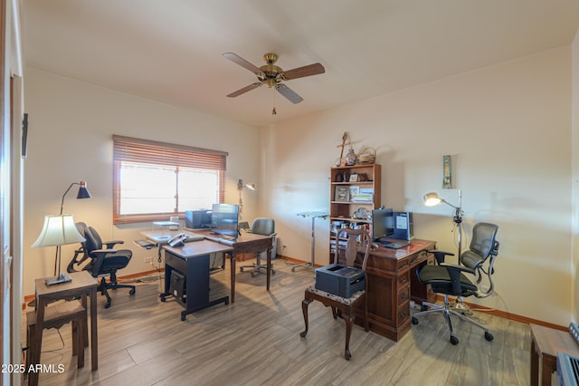 home office with hardwood / wood-style flooring and ceiling fan