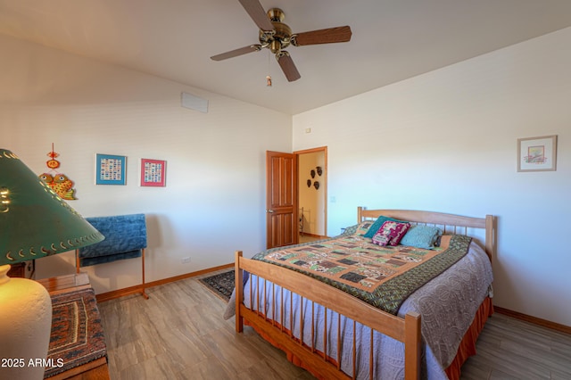 bedroom with vaulted ceiling, hardwood / wood-style floors, and ceiling fan