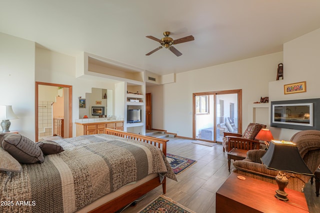 bedroom featuring ceiling fan and ensuite bathroom