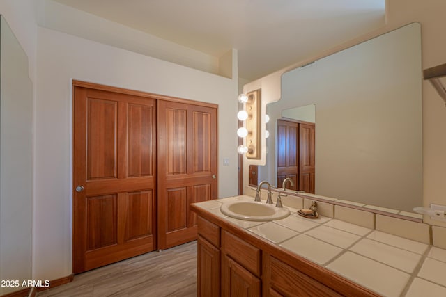 bathroom featuring wood-type flooring and vanity