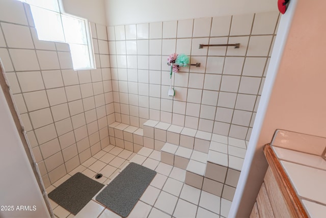 bathroom with tiled shower