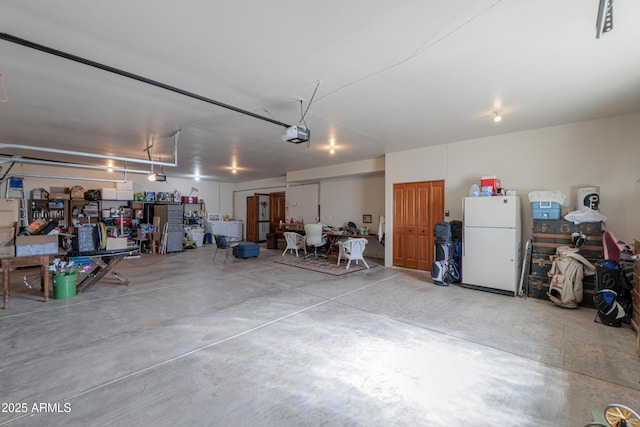 garage featuring a garage door opener and white refrigerator