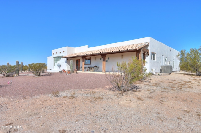 back of property featuring a patio and central AC