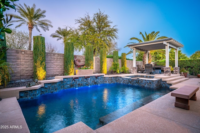 view of pool featuring a pool with connected hot tub, a patio, a pergola, and a fenced backyard