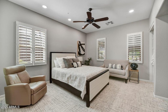 carpeted bedroom featuring ceiling fan, recessed lighting, visible vents, and baseboards