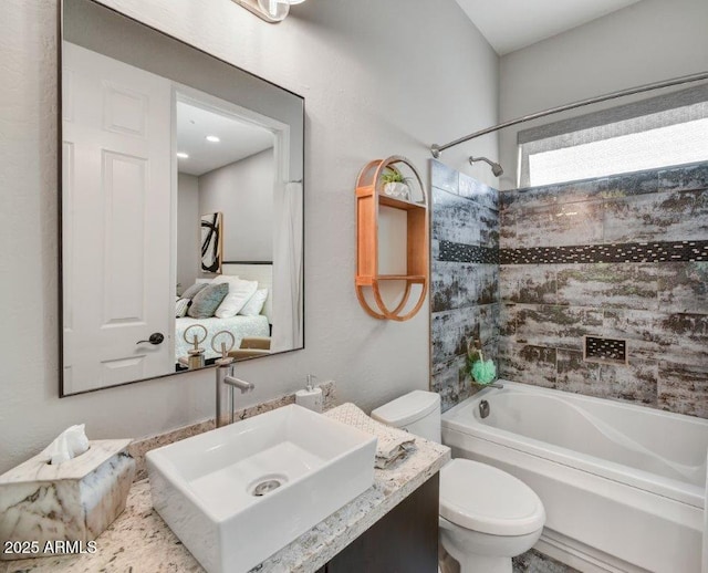 bathroom featuring vanity, toilet, and  shower combination