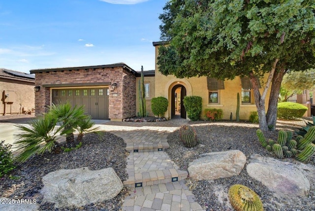 view of front of house featuring stucco siding and a garage