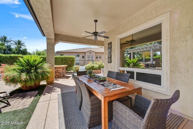 view of patio / terrace featuring outdoor dining area and a ceiling fan