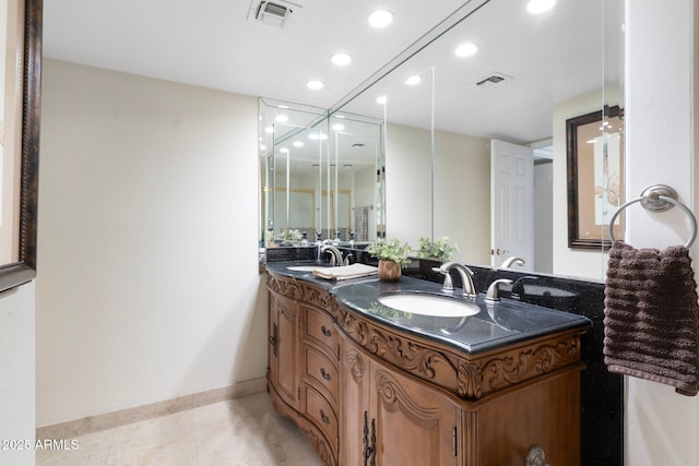 bathroom featuring tile patterned flooring and vanity