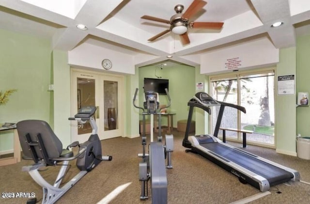 workout area featuring ceiling fan, french doors, and coffered ceiling