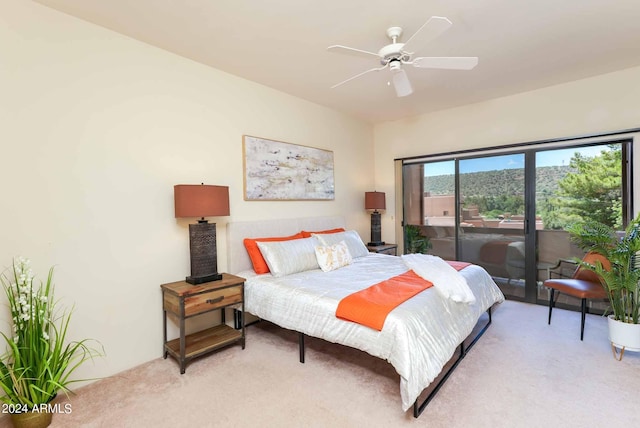 bedroom featuring light carpet, ceiling fan, and access to outside