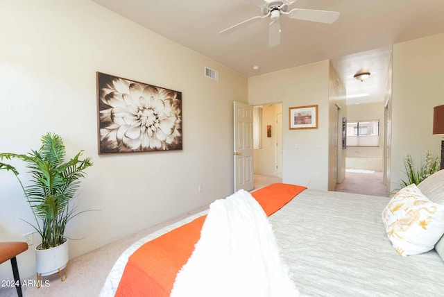 carpeted bedroom with ceiling fan and ensuite bathroom